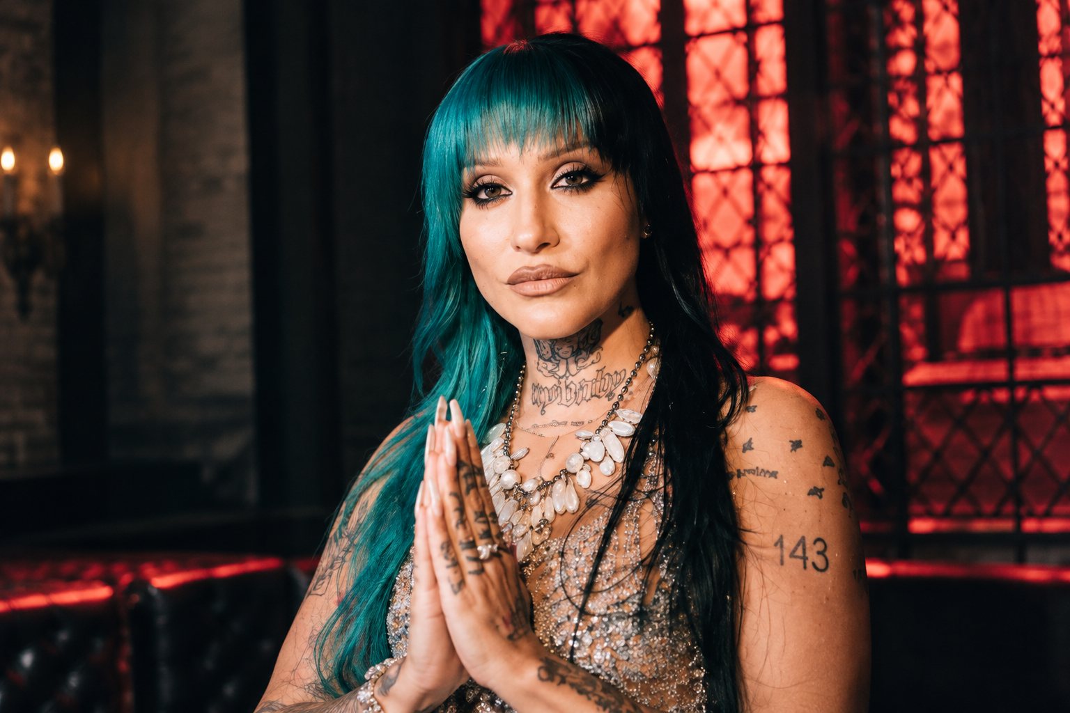 RØRY with blue hair performing in a leather jacket